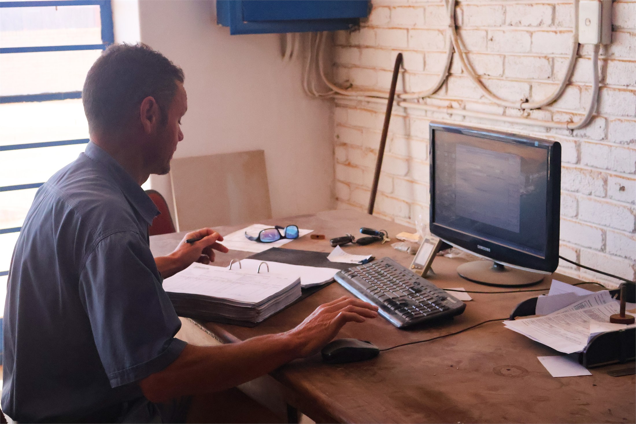 Stratalab team member reviewing test records at a laboratory workstation